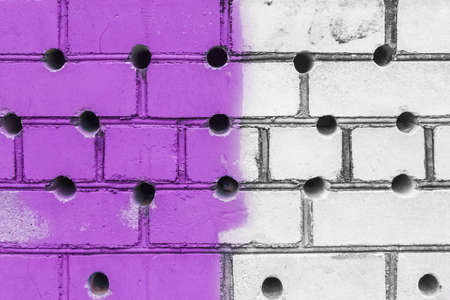 Abstract old design of dirty brick white wall with round holes pattern and purple paint texture background.の写真素材