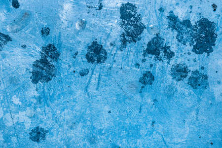 Black paint spots on old scratched metallic grunge texture steel dirty blue iron background.の写真素材