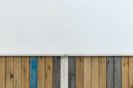 Wooden colored boards in the interior of the room with a white empty clean wall decoration design background.の写真素材