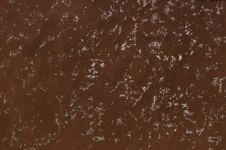 Brown dark plaster with abstract white pattern stucco wall texture background.