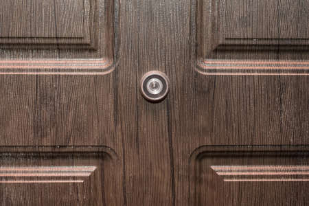 Peephole door eye look hole from spy security, safety close-up.の写真素材