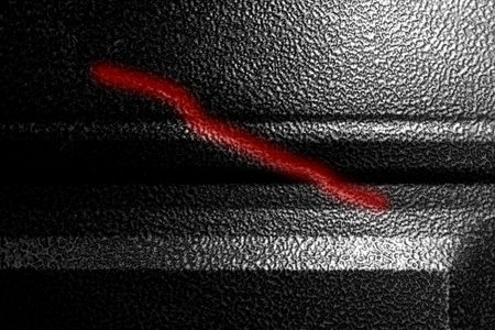 Scratch on iron structure, damaged metal surface, broken steel dent, close up.