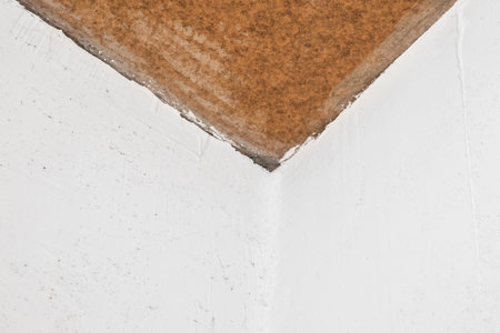 Repair of the joint of the two white plaster walls corner at the ceiling, the connecting link, construction work.の写真素材