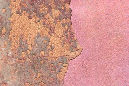 Crumbling peeling plaster with old colored wall surface texture rough background.