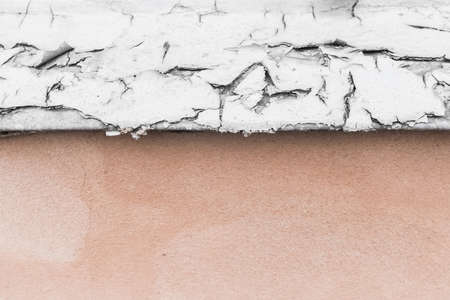Peeling cracked white paint on an old metal window sill surface wall texture background.の写真素材