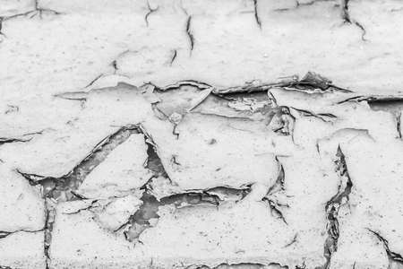 Cracked white paint on old weathered surface texture abstract background pattern.の写真素材