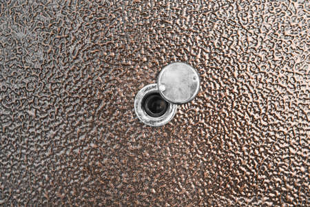 Peephole door eye look hole from spy security, safety close-up.の写真素材