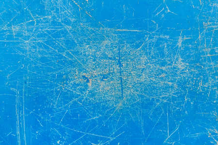 Worn plastic scratched weathered surface blue damaged cracked material abstract pattern old dirty background texture rough.の写真素材