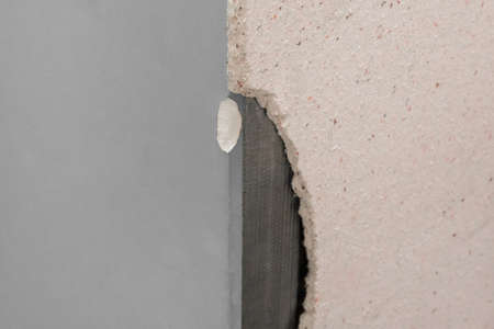 Repair of the old wall drywall renovation of the broken interior of the damaged structure construction.の写真素材