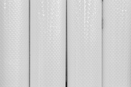 White wallpaper objects in rolls material for interior design and decoration of the house, close-up.
