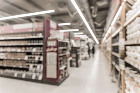 Blurry background of a hardware store with shelves and materials for interior and home design.の写真素材
