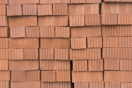 A bunch of brown brick building material on the construction site texture background.の写真素材