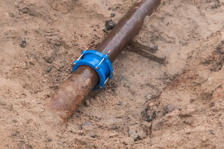 Flange coupling steel water pipe pipeline repair at construction site.の写真素材