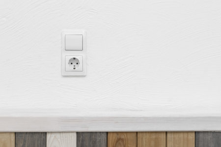 Socket and light off turn on button on the background of the switch white wall modern interior of...