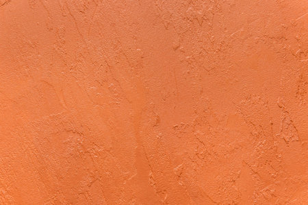 Orange Plaster Abstract Stucco Pattern Rough Wall Surface Design Texture Background.