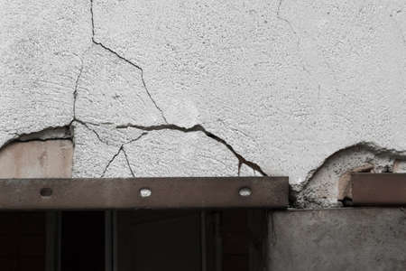 Old white cracked broken concrete texture cement wall damaged background.の写真素材
