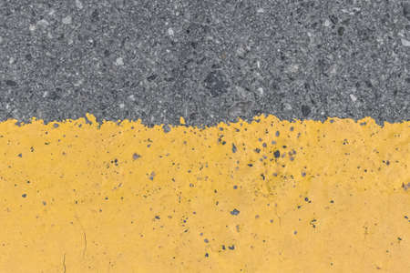 Asphalt street road markings with yellow paint abstract background design pattern.の写真素材