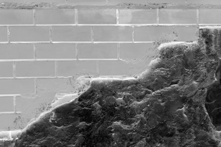 Gray paint on brick broken masonry wall with cement black dark concrete damaged facade background...