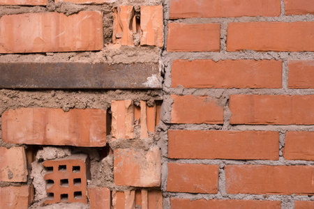 Non-standard improper unprofessional masonry of red or brown brick old building wall texture...