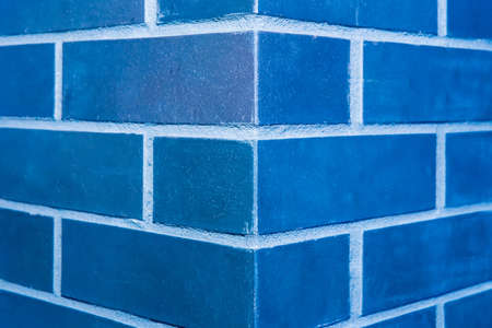 Corner brick column fragment close-up architecture of the joint blue wall of the interior texture background.の写真素材