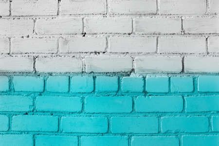 Brick wall paint in two colors azure or aquamarine and white abstract urban background design art texture.の写真素材