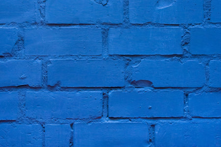 Blue paint brick wall of interior facade texture background architecture.