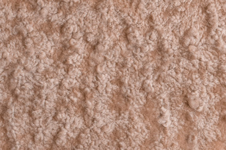 Brown beige fur wool abstract pattern nature skin soft warm fluffy background texture.