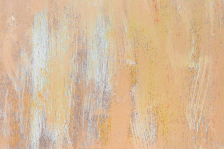 Yellow-brown retro paint on abstract metal surface pattern old steel texture outdated background.