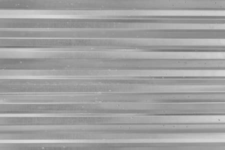 Corrugated Metal Silver Fence Steel Abstract Pattern Texture Gray Background.の写真素材