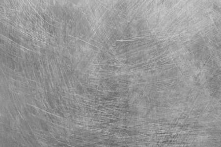 Gray scratched old metal surface steel abstract pattern texture silver background.の写真素材