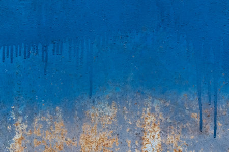 Blue paint liquid spilled streaks abstract pattern design surface wall texture background.の写真素材