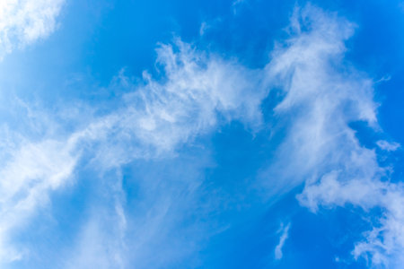 White fluffy soft clouds sky wind blue weather change natural background.の写真素材