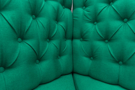 Green leather upholstery sofa corner pattern button design furniture style decor texture background decoration vintage material.の写真素材