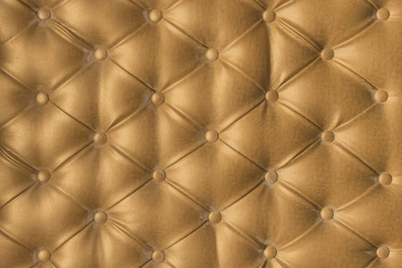 Gold leather upholstery sofa pattern button design furniture style decor texture background decoration vintage golden abstract.の写真素材