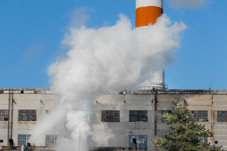 Emission of caustic toxic steam smoke at the plant industry and pollution of the environment, air and atmosphere, environmental problems.の写真素材