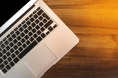 Keyboard laptop table workspace empty workplace job work business blank wooden desk modern background.の写真素材