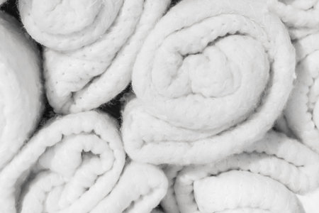 Set of soft white knitted light woolen fabric cotton bright blankets vintage background, close-up.の写真素材