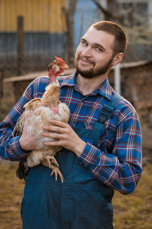 Farmer handsome smiling European Caucasian rural portrait in countryside with beard, shirt and...