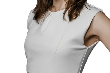 Slim adult girl posing in tight-fitting white sleeveless dress or with open arms on a isolated background, women's fashion and clothing style.の写真素材