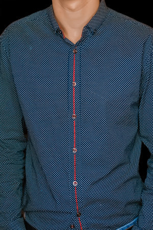 Men's business style clothing skinny guy fashion blue shirt on dark background, close up.の写真素材