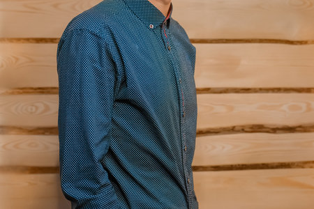 Men's business style clothing skinny guy fashion in blue shirt on wooden background.の写真素材