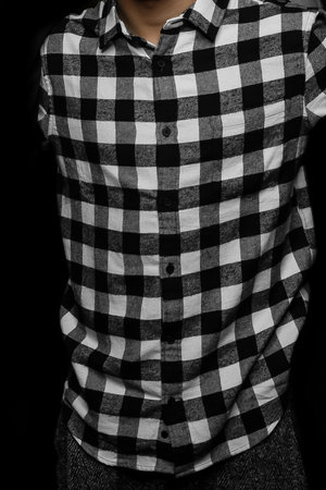 Men's abstract clothing style business fashion plaid shirt black and white checkered pattern on dark background.の写真素材