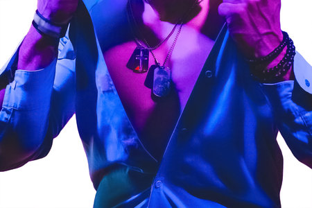Men's light unbuttoned shirt with military tokens around the neck in blue and purple neon light on a white background isolated.の写真素材