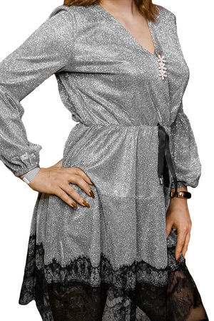 Girl posing in silver gray beautiful dress, shiny, fashion and style of clothing with black fringe on white background, isolated, close up.の写真素材