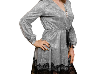 Girl posing in silver gray beautiful dress, shiny, fashion and style of clothing with black fringe on white background, isolated.の写真素材
