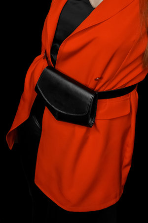 Girl in a red suit, jacket and black tank top and black bag on her belt, fashion and style of clothing.の写真素材