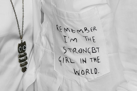 White clothes, light fashion and style, decoration, English lettering on the pocket, close-up, soft focus, macro.の写真素材