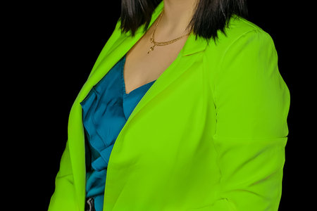 Person in blue clothes and bright green jacket women's fashion and style on black background isolated.の写真素材