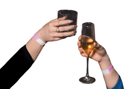 The hands of girls, friends clinking glasses of alcoholic beverages on a white background, isolated, holiday atmosphere, weekend.の写真素材