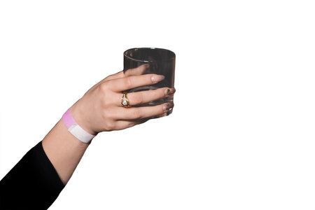 The hand of girl holding a glass of beverage on a white background, isolated, holiday weekend.の写真素材